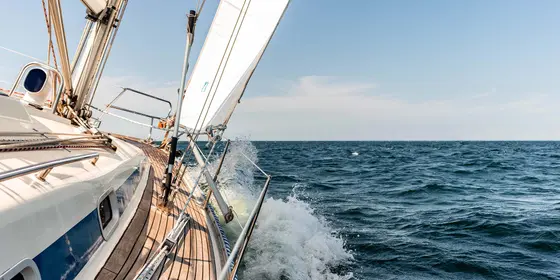 Yacht cruising along the coastline